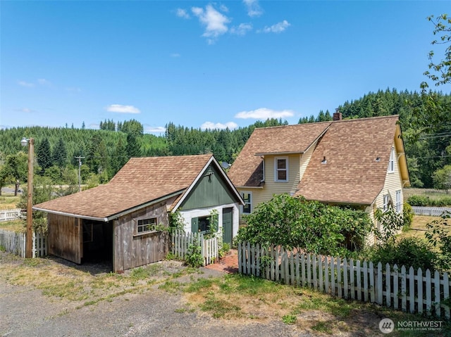 1129 Bunker Creek Rd, Chehalis, WA 98532 - view of front of home with a forest view and a chimney