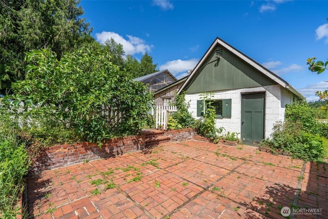 1129 Bunker Creek Rd, Chehalis, WA 98532 - back of house with concrete block siding and a patio area