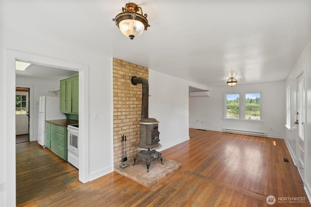 1129 Bunker Creek Rd, Chehalis, WA 98532 - unfurnished living room with a wood stove, a baseboard heating unit, hardwood / wood-style floors, and a wall unit AC