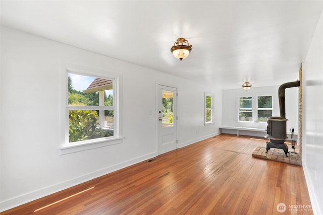 1129 Bunker Creek Rd, Chehalis, WA 98532 - unfurnished living room featuring a wood stove and hardwood / wood-style flooring