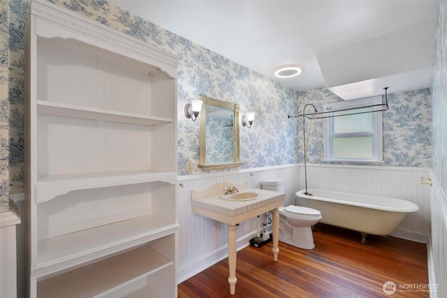 1129 Bunker Creek Rd, Chehalis, WA 98532 - bathroom featuring wallpapered walls, a wainscoted wall, and wood finished floors