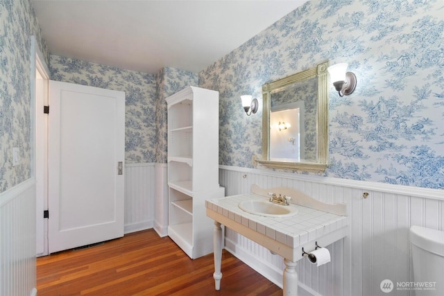 1129 Bunker Creek Rd, Chehalis, WA 98532 - bathroom with wood finished floors, wainscoting, and wallpapered walls