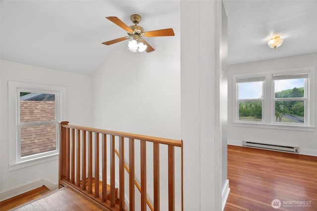1129 Bunker Creek Rd, Chehalis, WA 98532 - hallway featuring baseboard heating, wood finished floors, an upstairs landing, and vaulted ceiling