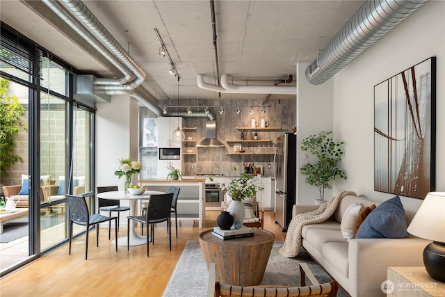 2720 3rd Ave Unit 412, Seattle, WA 98121 - living area featuring light wood-style flooring and rail lighting