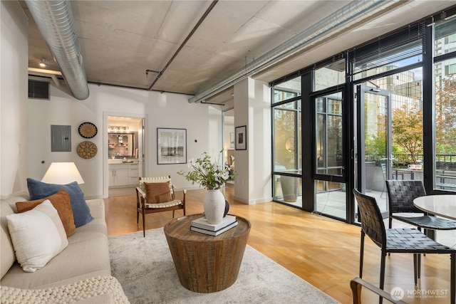 2720 3rd Ave Unit 412, Seattle, WA 98121 - living room with healthy amount of natural light, light wood-style flooring, and electric panel