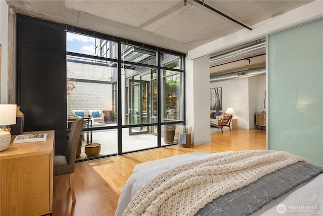 2720 3rd Ave Unit 412, Seattle, WA 98121 - bedroom featuring wood finished floors and expansive windows