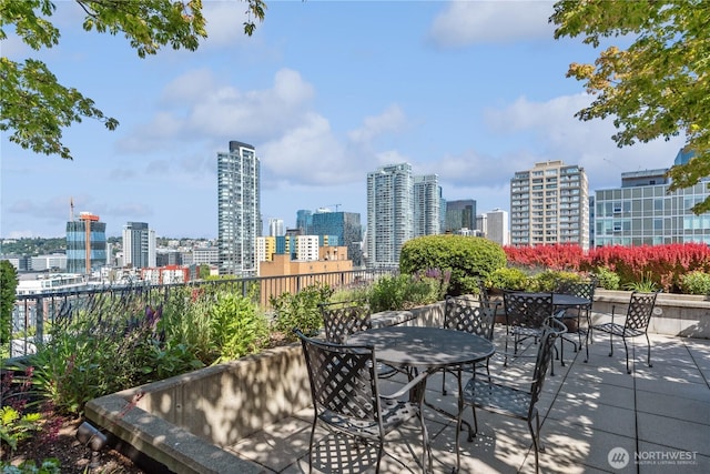 2720 3rd Ave Unit 412, Seattle, WA 98121 - view of patio / terrace featuring outdoor dining space and a skyline view