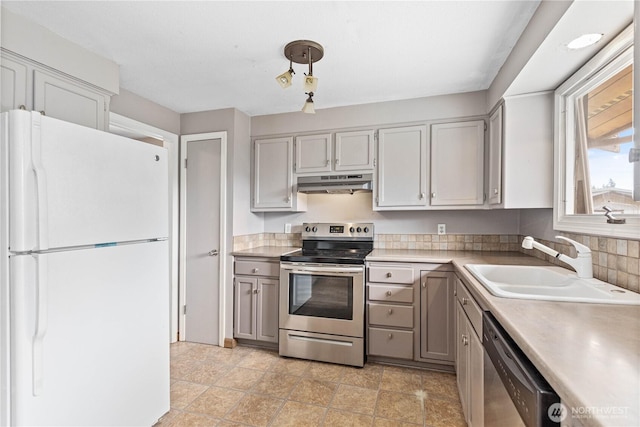 8374 W Meadow Ln, Lynden, WA 98264 - kitchen with stainless steel appliances, under cabinet range hood, gray cabinets, and light countertops