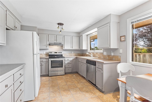 8374 W Meadow Ln, Lynden, WA 98264 - kitchen with appliances with stainless steel finishes, gray cabinets, healthy amount of natural light, and under cabinet range hood