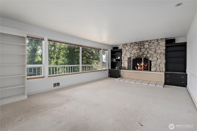 5017 Harbor Hills Dr, Freeland, WA 98249 - unfurnished living room featuring carpet flooring, a stone fireplace, and built in features