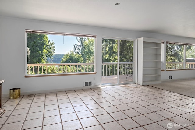5017 Harbor Hills Dr, Freeland, WA 98249 - unfurnished room with healthy amount of natural light, light tile patterned flooring, built in features, and crown molding