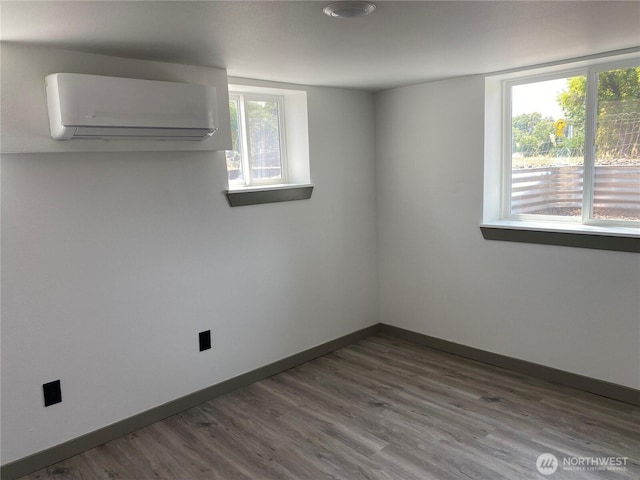 604 SW 4th St, College Place, WA 99324 - spare room with a wall unit AC and dark wood-style floors