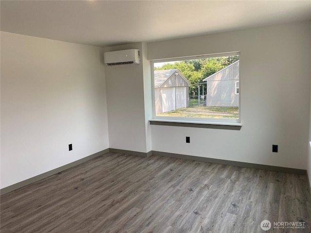 604 SW 4th St, College Place, WA 99324 - spare room featuring a wall mounted air conditioner and wood finished floors