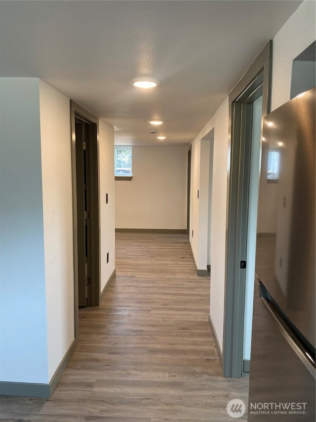 604 SW 4th St, College Place, WA 99324 - corridor featuring wood finished floors and baseboards
