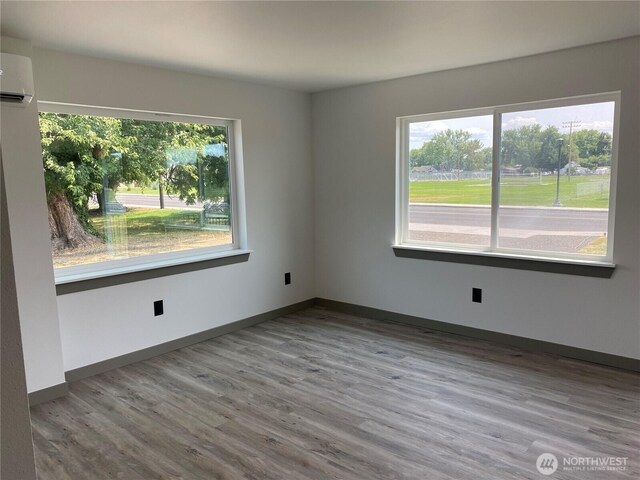 604 SW 4th St, College Place, WA 99324 - unfurnished room featuring wood finished floors and an AC wall unit