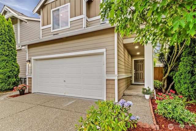 17710 39th Ave SE, Bothell, WA 98012 - view of front of home with an attached garage, concrete driveway, and board and batten siding