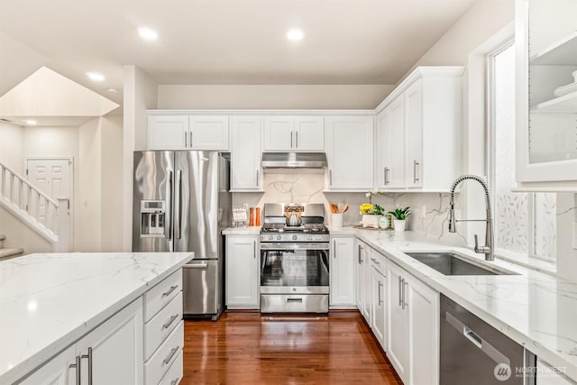 17710 39th Ave SE, Bothell, WA 98012 - kitchen with appliances with stainless steel finishes, under cabinet range hood, white cabinets, light stone counters, and dark wood finished floors