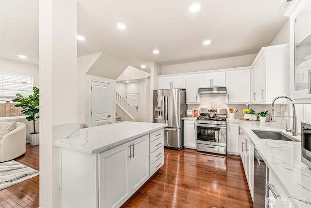 17710 39th Ave SE, Bothell, WA 98012 - kitchen with appliances with stainless steel finishes, exhaust hood, wood finished floors, white cabinets, and light stone counters