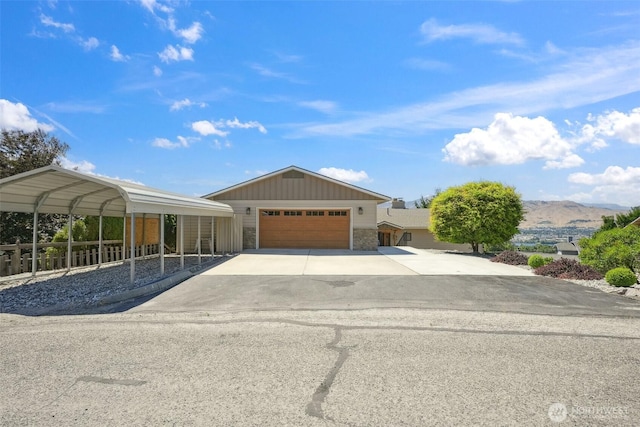 622 Vista View Pl, East Wenatchee, WA 98802 - ranch-style house with stone siding, a garage, board and batten siding, a mountain view, and concrete driveway