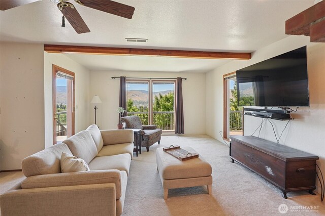 622 Vista View Pl, East Wenatchee, WA 98802 - living room featuring beam ceiling, healthy amount of natural light, a ceiling fan, and light colored carpet