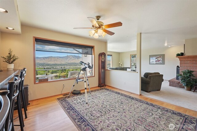 622 Vista View Pl, East Wenatchee, WA 98802 - interior space featuring a ceiling fan, a brick fireplace, wood finished floors, and a mountain view