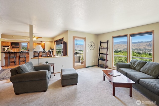 622 Vista View Pl, East Wenatchee, WA 98802 - living area featuring light colored carpet, ceiling fan, and a mountain view