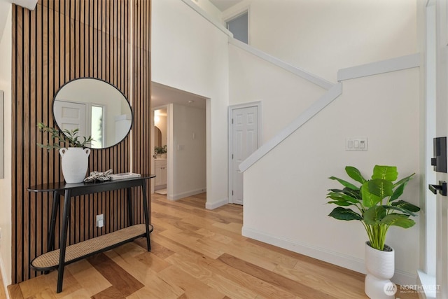 9132 NE 143rd Pl, Kirkland, WA 98034 - hall featuring light wood-type flooring, a towering ceiling, and stairs