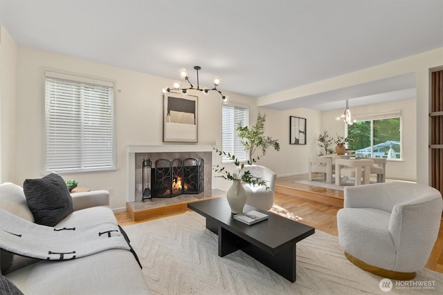 9132 NE 143rd Pl, Kirkland, WA 98034 - living area featuring a chandelier, plenty of natural light, light wood-style flooring, and a lit fireplace