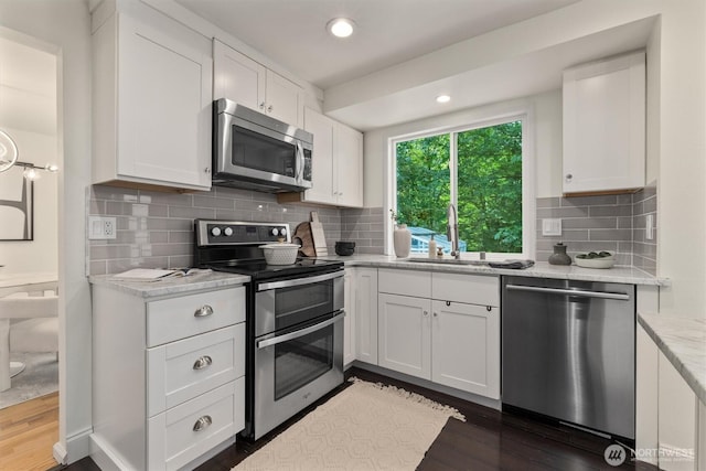 9132 NE 143rd Pl, Kirkland, WA 98034 - kitchen featuring stainless steel appliances, dark wood-style floors, white cabinets, decorative backsplash, and light stone countertops