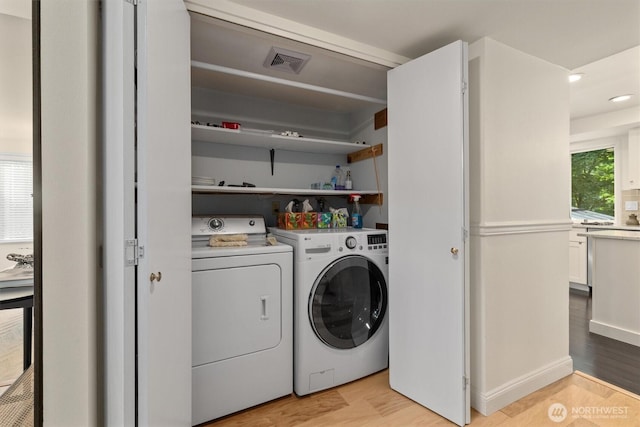 9132 NE 143rd Pl, Kirkland, WA 98034 - laundry area featuring light wood-style floors, washer and clothes dryer, and recessed lighting