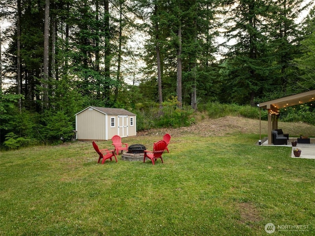 118 Bald Eagle Rd, Ariel, WA 98603 - view of grassy yard featuring an outdoor fire pit, a storage shed, and a patio