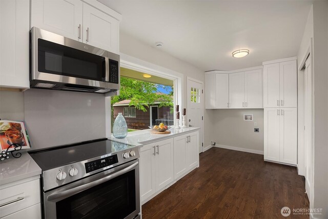 7337 19th Ave SW, Seattle, WA 98106 - kitchen featuring appliances with stainless steel finishes, light countertops, white cabinets, and dark wood-style flooring