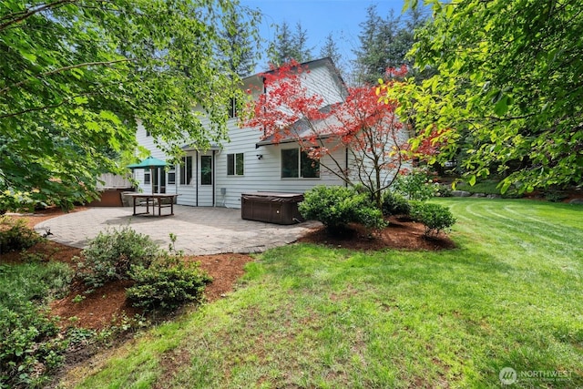 6211 18th Ave SW, Olympia, WA 98512 - rear view of house with a hot tub, a patio, and a yard