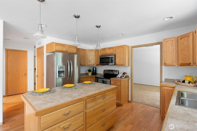 6211 18th Ave SW, Olympia, WA 98512 - kitchen with stainless steel appliances, light wood-style flooring, a center island, hanging light fixtures, and recessed lighting
