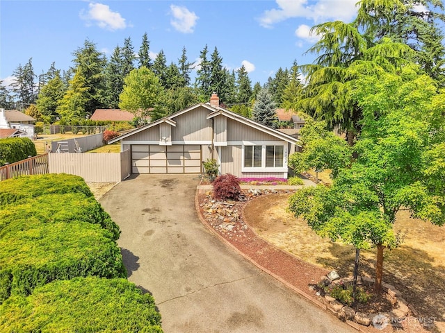 16002 5th Ave E, Tacoma, WA 98445 - mid-century modern home with driveway, an attached garage, and a chimney