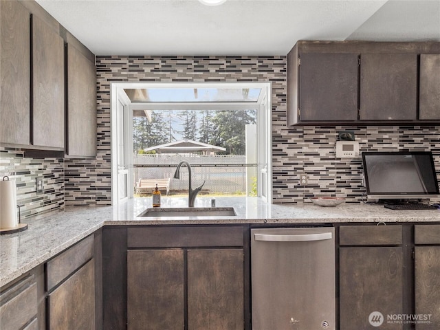 16002 5th Ave E, Tacoma, WA 98445 - kitchen featuring dishwasher, tasteful backsplash, dark brown cabinetry, and light stone counters