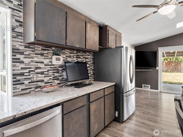 16002 5th Ave E, Tacoma, WA 98445 - kitchen featuring a ceiling fan, stainless steel appliances, lofted ceiling, decorative backsplash, and light wood-style floors