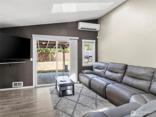 16002 5th Ave E, Tacoma, WA 98445 - living area with a wall mounted AC, a skylight, wood finished floors, and vaulted ceiling