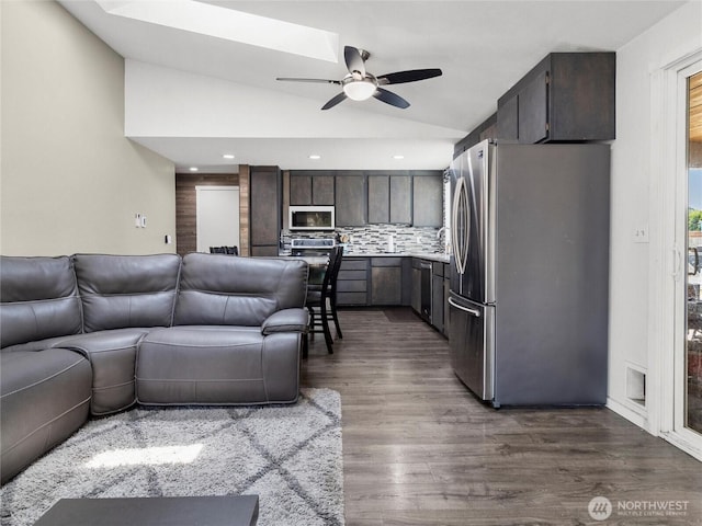 16002 5th Ave E, Tacoma, WA 98445 - living area with vaulted ceiling, a ceiling fan, and dark wood-type flooring