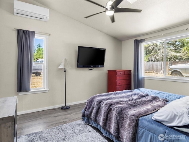 16002 5th Ave E, Tacoma, WA 98445 - bedroom with a wall unit AC, wood finished floors, vaulted ceiling, multiple windows, and ceiling fan