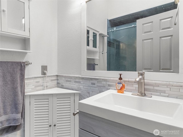 16002 5th Ave E, Tacoma, WA 98445 - bathroom with vanity, tile walls, a shower stall, a wainscoted wall, and backsplash