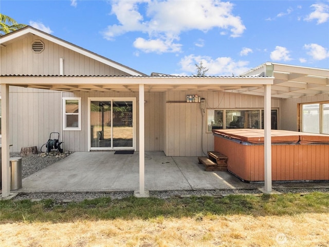 16002 5th Ave E, Tacoma, WA 98445 - back of house featuring a hot tub, a patio, and a metal roof