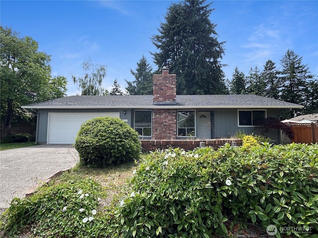 5519 65th Ave SE, Olympia, WA 98513 - single story home featuring a chimney, asphalt driveway, and an attached garage