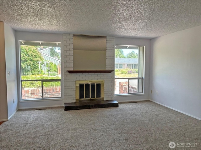 5519 65th Ave SE, Olympia, WA 98513 - unfurnished living room with carpet, a textured ceiling, healthy amount of natural light, and a brick fireplace