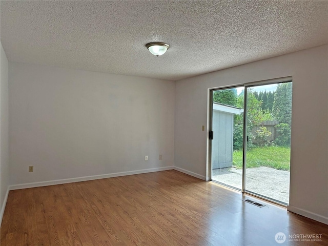 5519 65th Ave SE, Olympia, WA 98513 - unfurnished room with wood finished floors and a textured ceiling