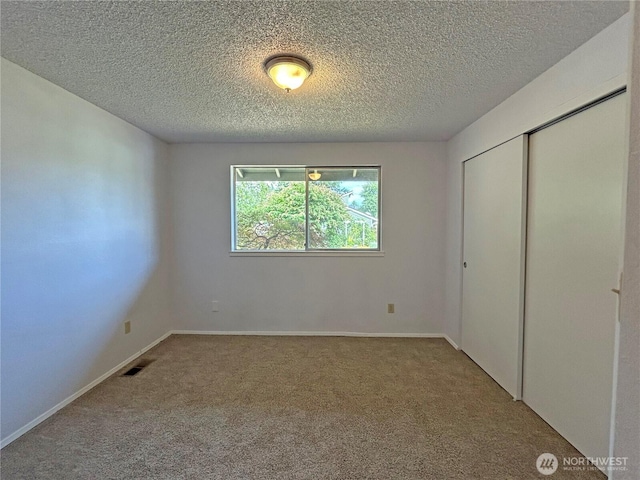 5519 65th Ave SE, Olympia, WA 98513 - unfurnished bedroom with carpet flooring, a closet, and a textured ceiling