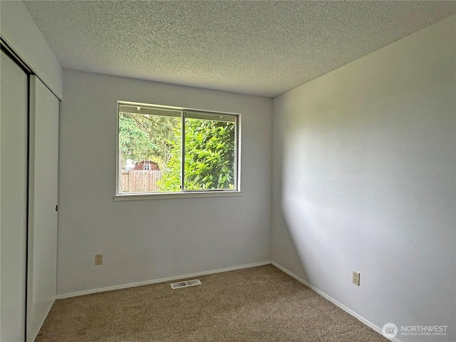 5519 65th Ave SE, Olympia, WA 98513 - unfurnished bedroom featuring a closet, carpet flooring, and a textured ceiling