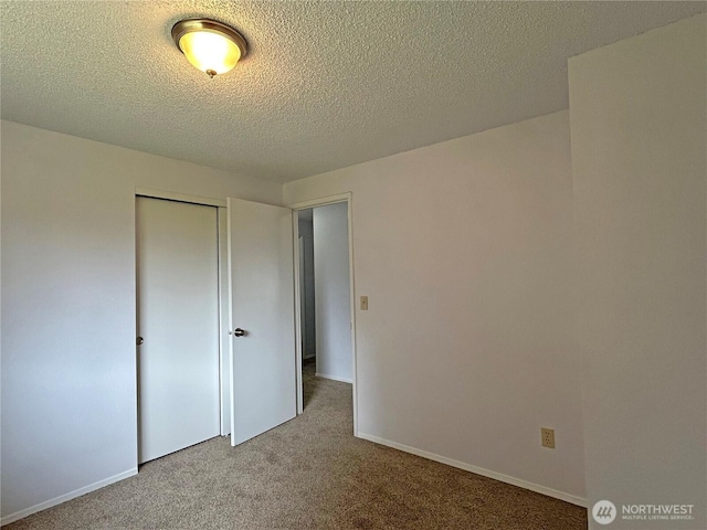 5519 65th Ave SE, Olympia, WA 98513 - unfurnished bedroom with carpet floors, a closet, and a textured ceiling