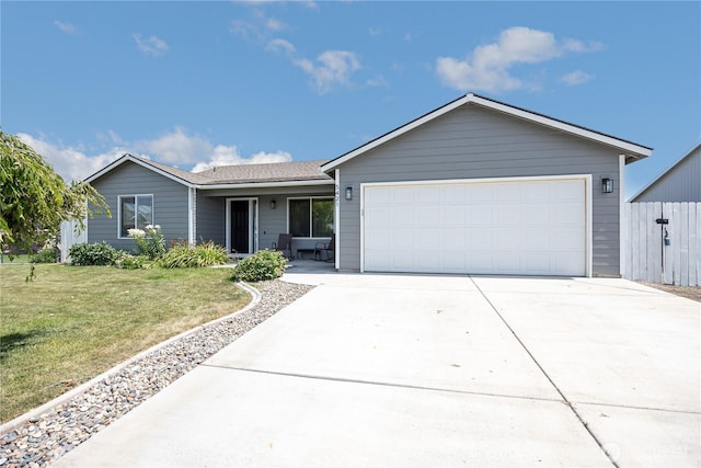 5421 Jackson Ln, Pasco, WA 99301 - ranch-style home featuring concrete driveway, a front lawn, and an attached garage