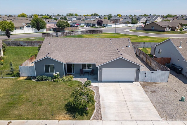 5421 Jackson Ln, Pasco, WA 99301 - ranch-style home with a garage, a residential view, driveway, and roof with shingles